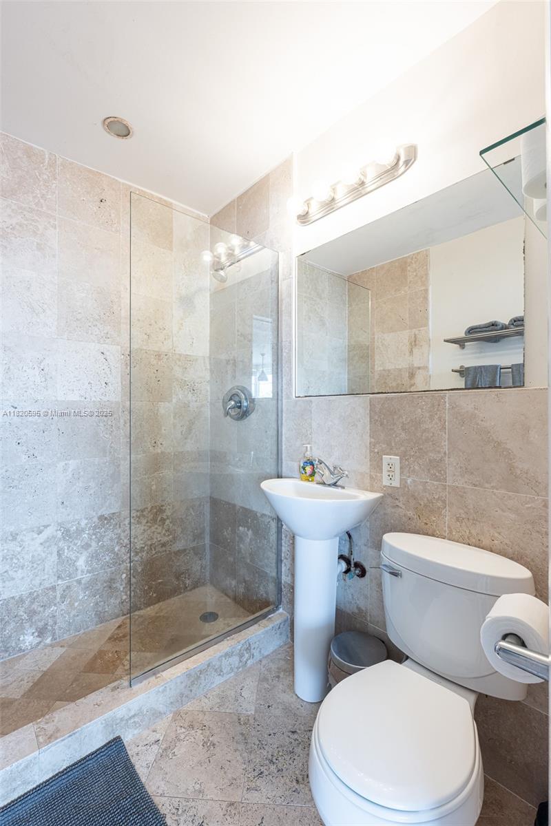 420 15th Street, Unit 307 Miami Beach, FL 33139 - Photo 17 of 22 a white toilet sitting next to a bath tub
