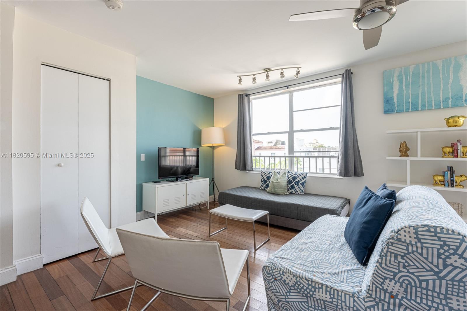 420 15th Street, Unit 307 Miami Beach, FL 33139 - Photo 3 of 22 a living room with furniture and a flat screen tv