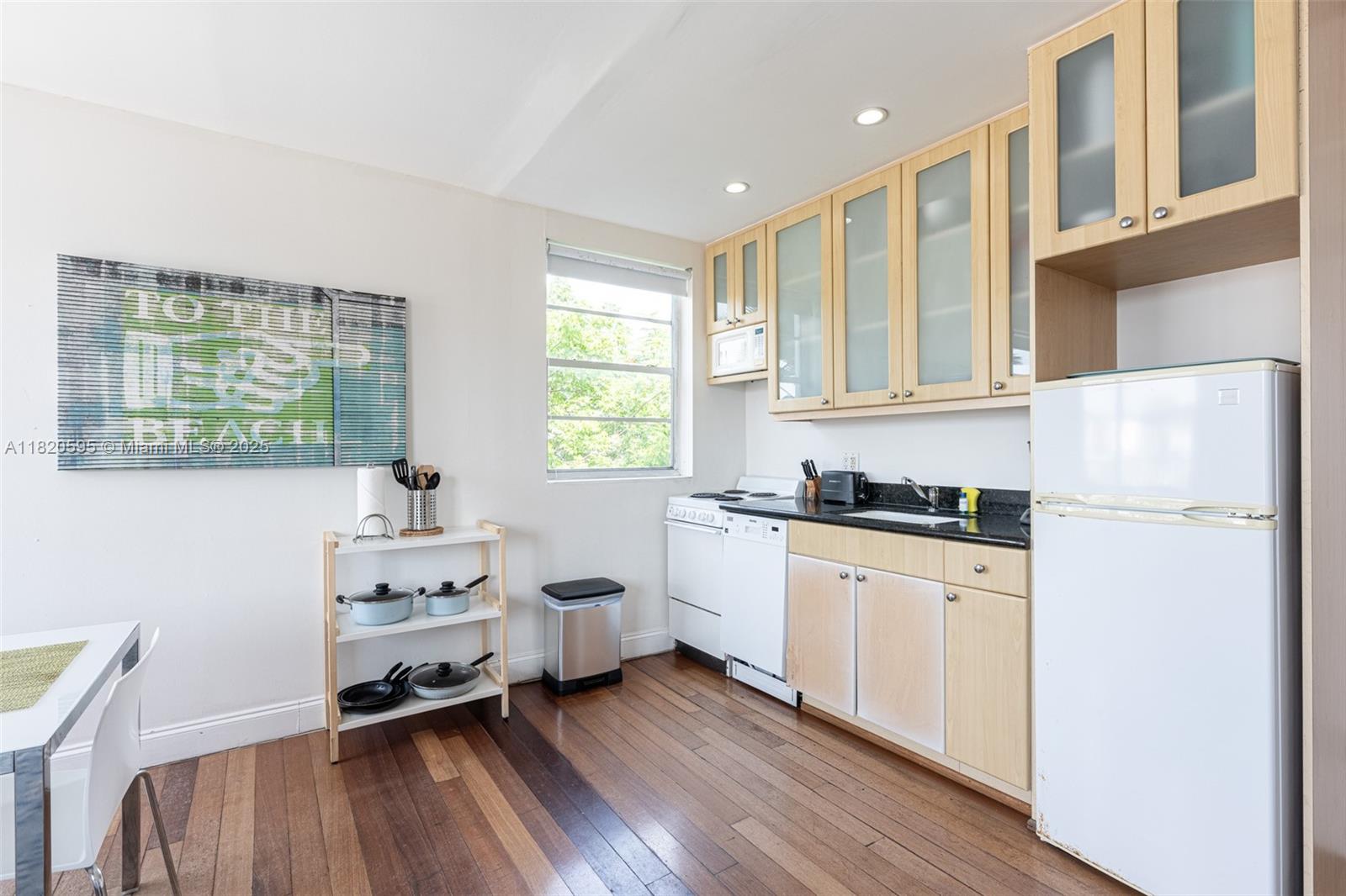 420 15th Street, Unit 307 Miami Beach, FL 33139 - Photo 8 of 22 a kitchen with stainless steel appliances a stove a sink and a refrigerator