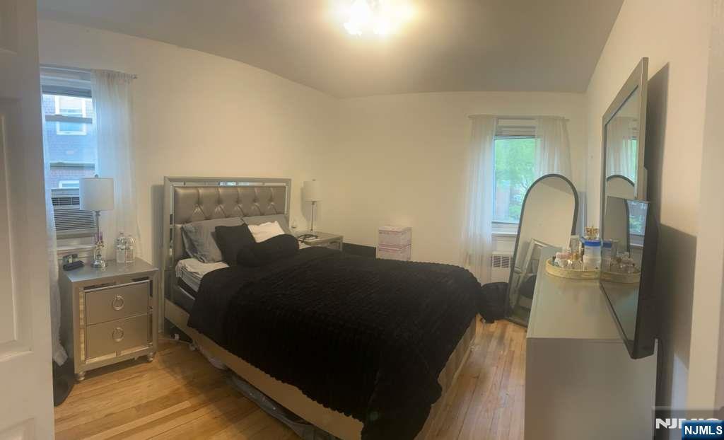 1480 Terrace, Unit 4 Teaneck, NJ 07666 - Photo 9 of 14 a bed sitting in a bedroom next to a window