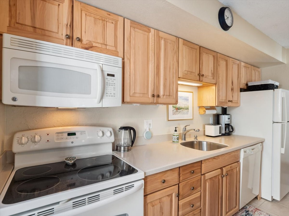 1161 Ski Hill Road, Unit 141 Breckenridge, CO 80424 - Photo 12 of 22 a kitchen with white cabinets and white appliances