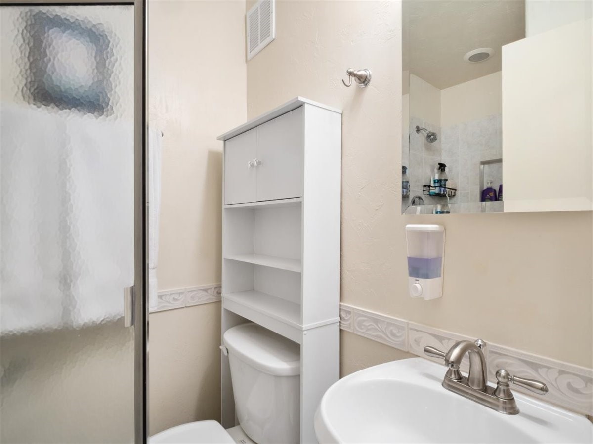 1161 Ski Hill Road, Unit 141 Breckenridge, CO 80424 - Photo 15 of 22 a bathroom with a sink toilet and mirror