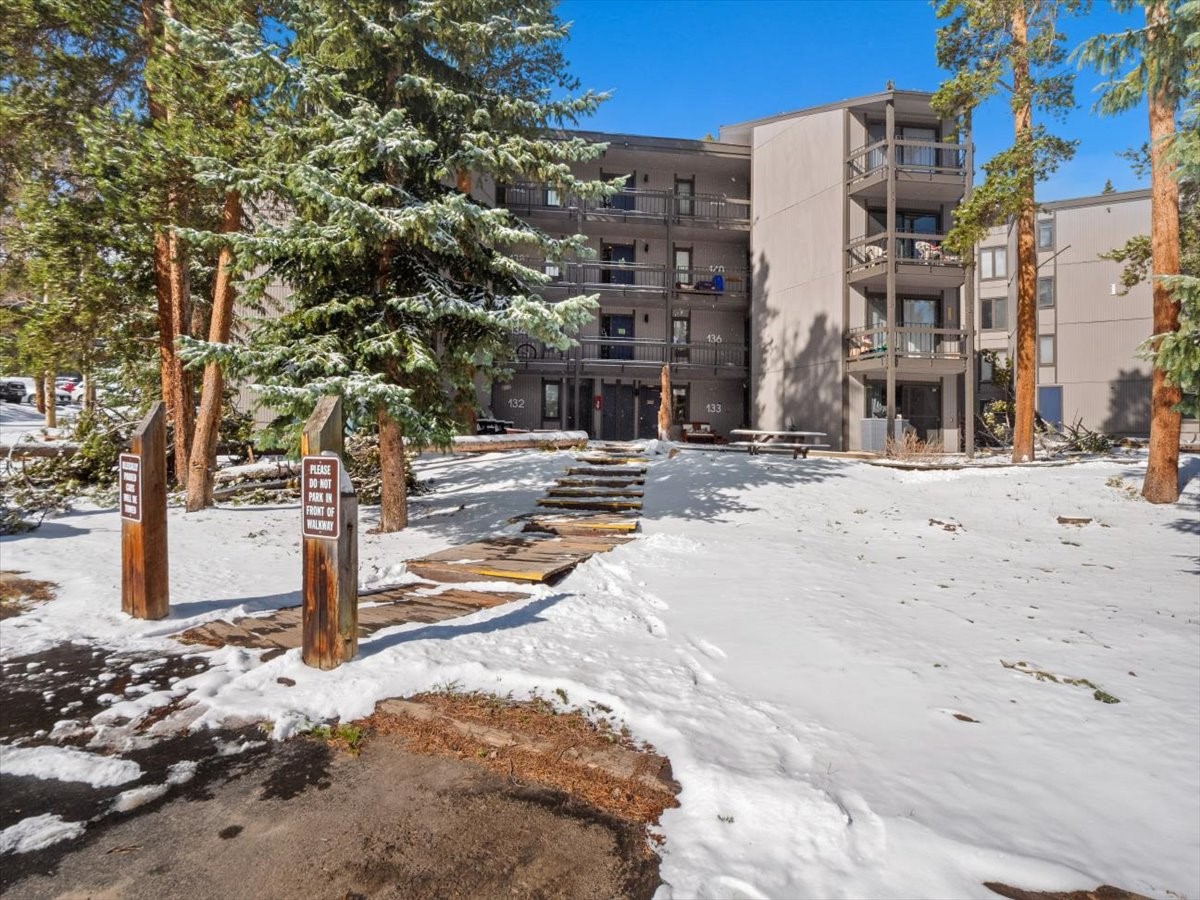 1161 Ski Hill Road, Unit 141 Breckenridge, CO 80424 - Photo 22 of 22 a view of a building with snow on the road
