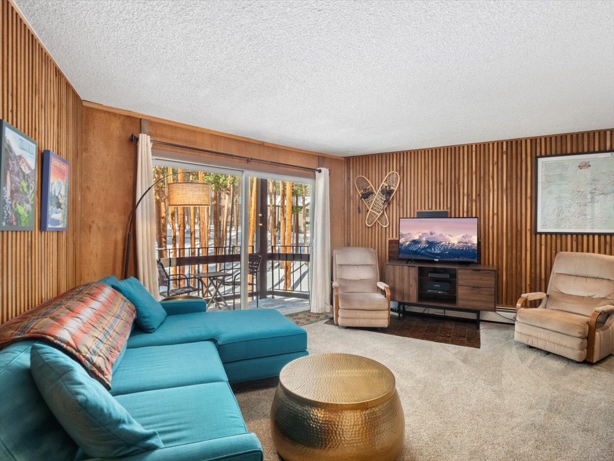 1161 Ski Hill Road, Unit 141 Breckenridge, CO 80424 - Photo 3 of 22 a living room with furniture and a flat screen tv