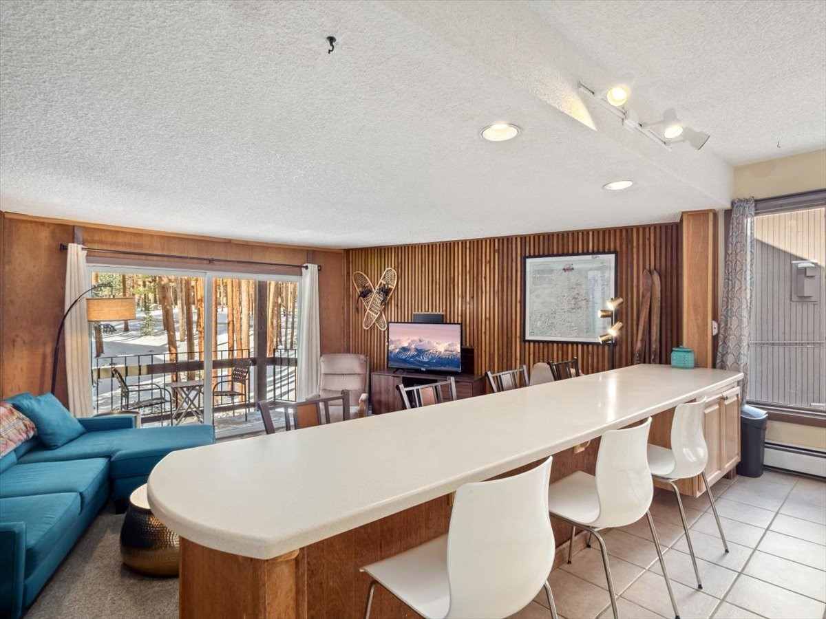 1161 Ski Hill Road, Unit 141 Breckenridge, CO 80424 - Photo 7 of 22 a living room with furniture a large window and kitchen view