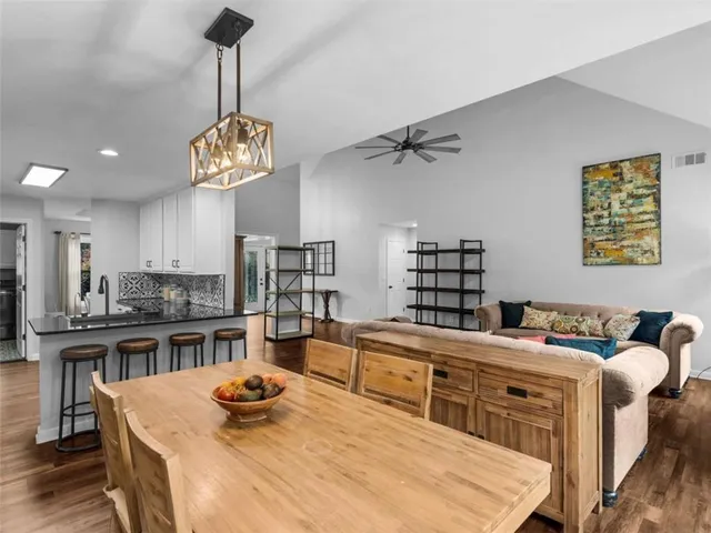 a bathroom with a granite countertop toilet a sink and a bathtub