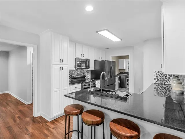 a bedroom with a bed a dresser and a large mirror