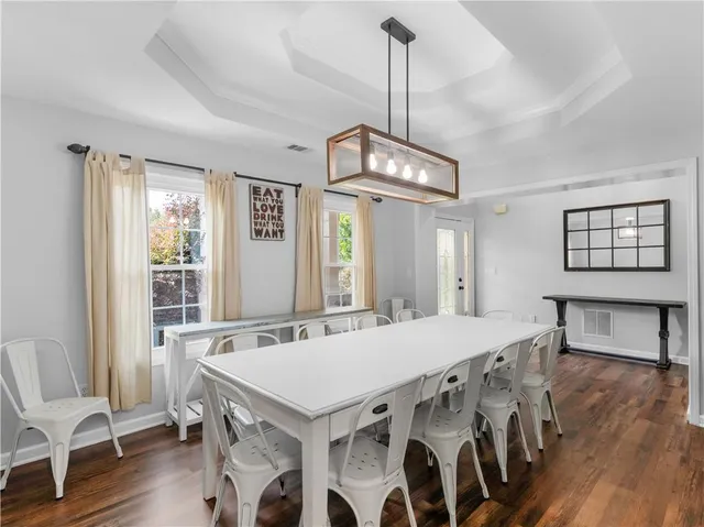 a living room with furniture and a view of kitchen