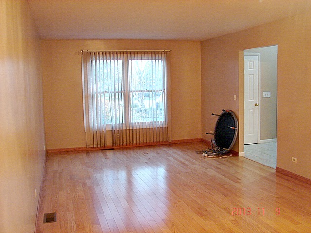 5353 Joshua Court Gurnee, IL 60031 - Photo 3 of 22 a view of a room with wooden floor and windows