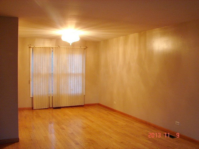 5353 Joshua Court Gurnee, IL 60031 - Photo 4 of 22 a view of a room with an empty space and a window