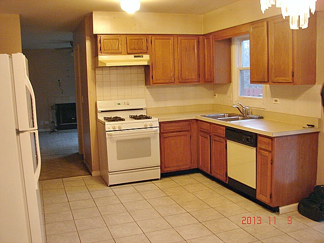5353 Joshua Court Gurnee, IL 60031 - Photo 5 of 22 a kitchen with a sink appliances and cabinets