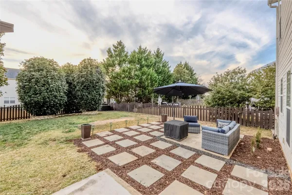 a view of backyard of house with seating space
