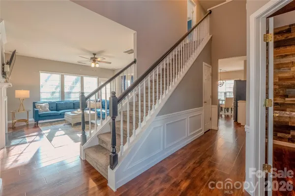a view of entryway and hall with wooden floor