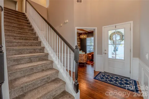 a view of entryway and hall with wooden floor