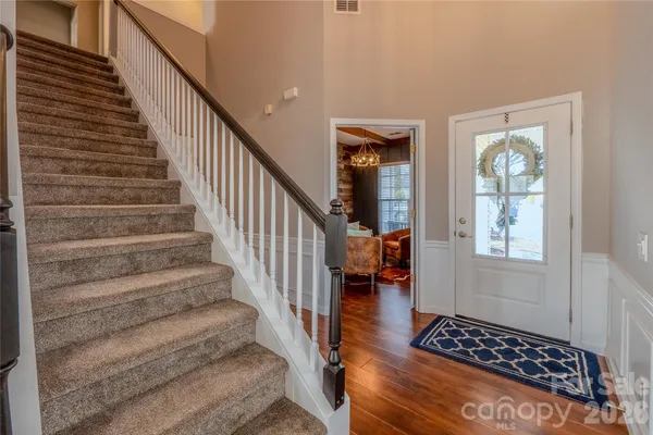 a view of entryway and hall with wooden floor