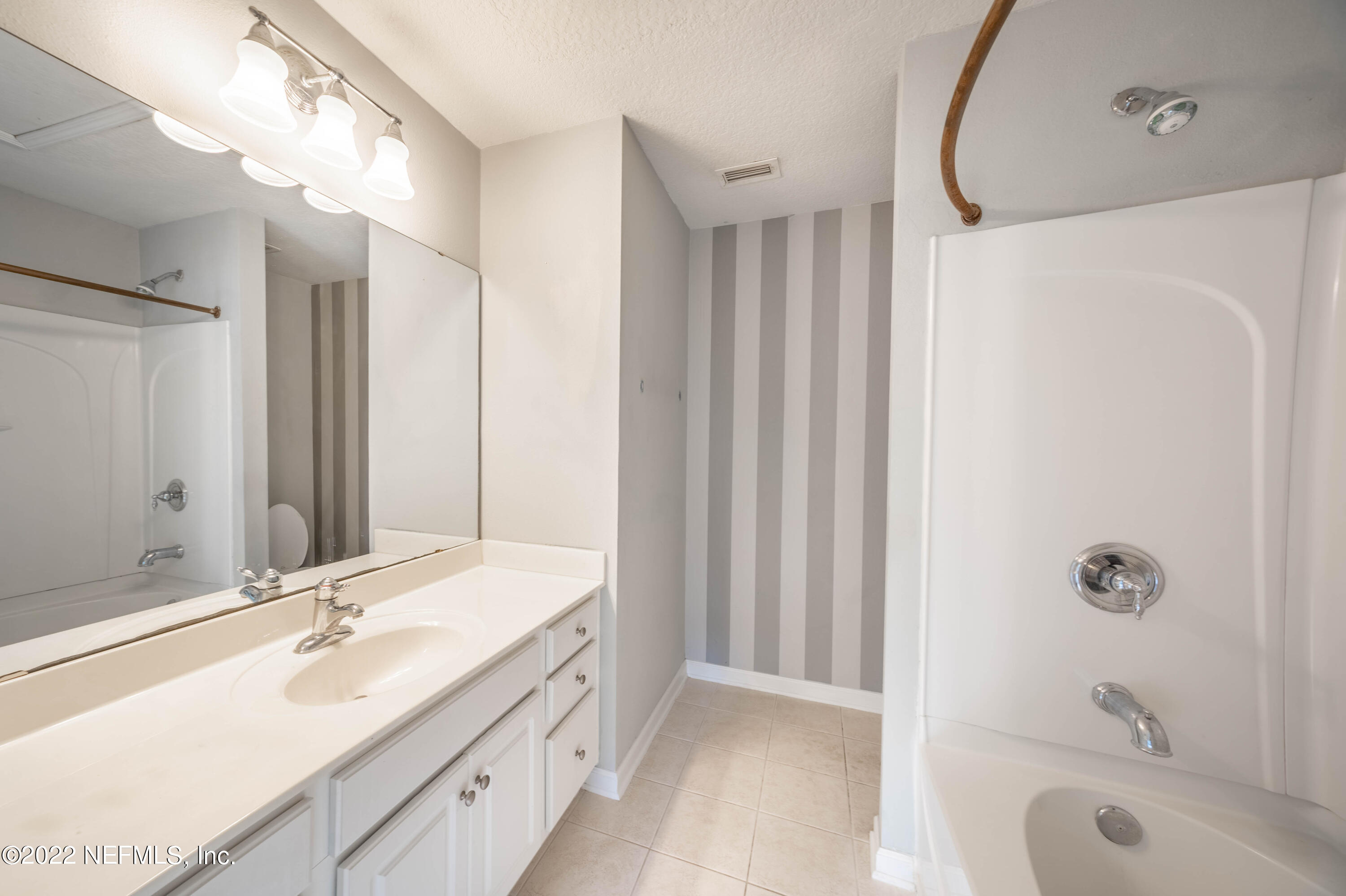 8085 Summerside Circle Jacksonville, FL 32256 - Photo 14 of 21 a bathroom with a tub sink and mirror
