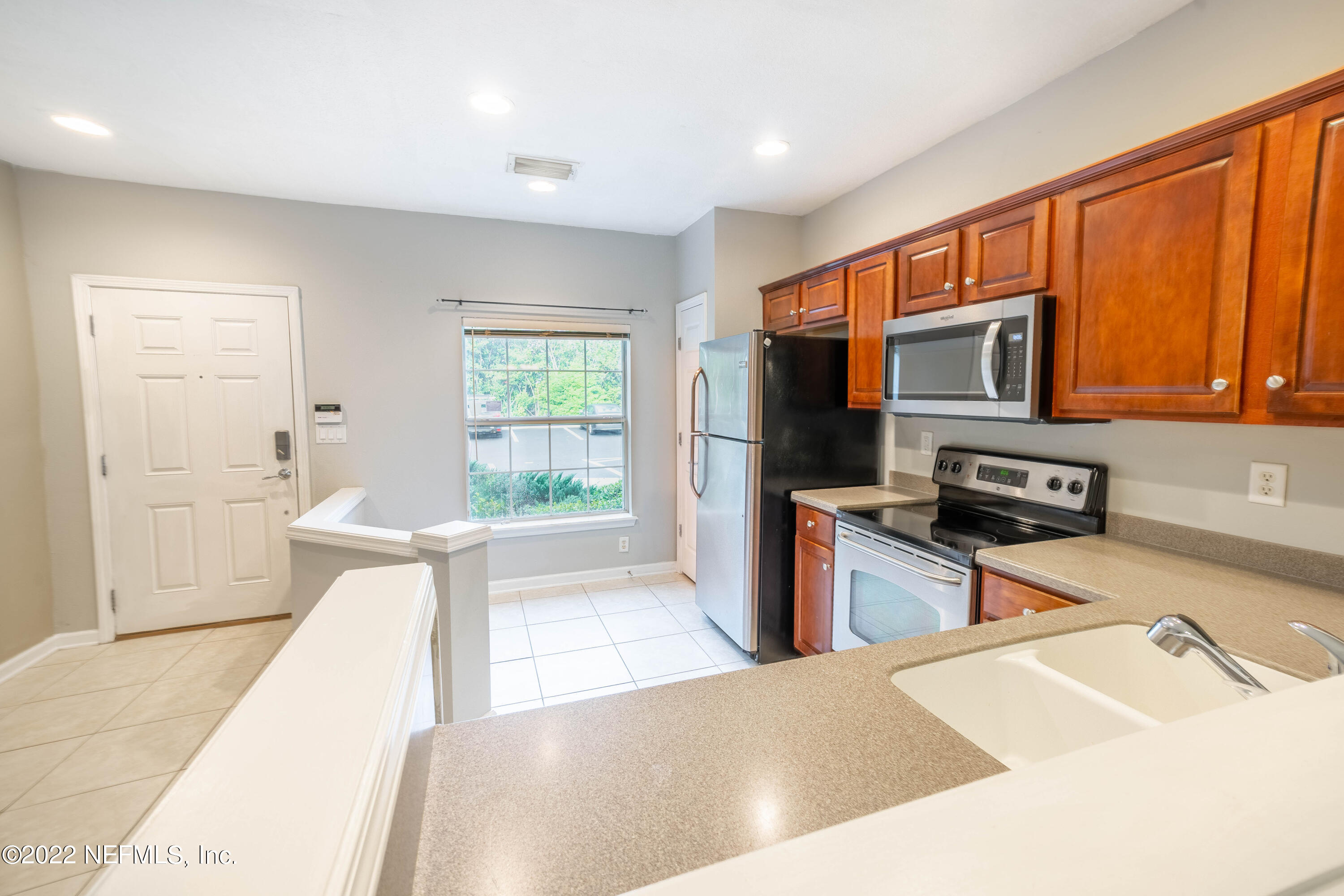 8085 Summerside Circle Jacksonville, FL 32256 - Photo 9 of 21 a kitchen with stainless steel appliances granite countertop a stove a sink and a refrigerator