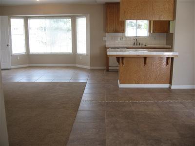 Darling bay window in the dining area with lots of extra 12" X 12" tile in entry, dining,kitchen, laundry, hallway & bath