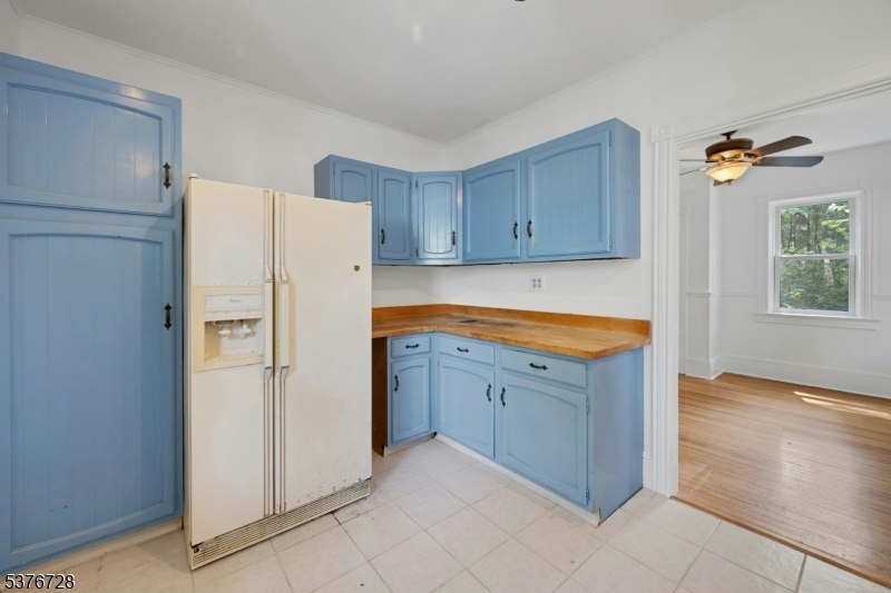 59 Main Street Peapack-Gladstone, NJ 07977 - Photo 12 of 30 a kitchen with a refrigerator sink and cabinets