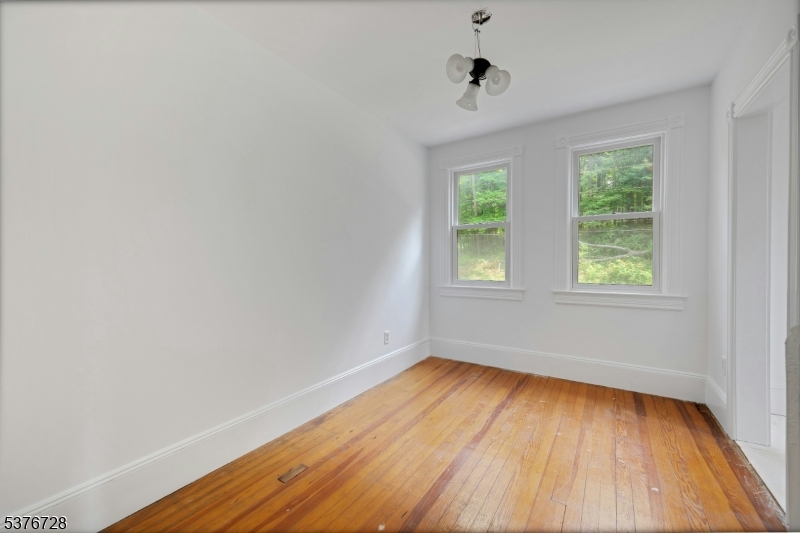 59 Main Street Peapack-Gladstone, NJ 07977 - Photo 14 of 30 a view of an empty room with wooden floor and a window