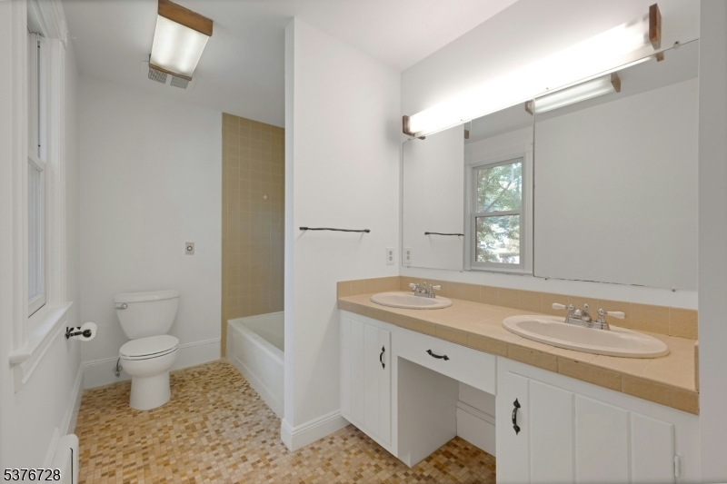 59 Main Street Peapack-Gladstone, NJ 07977 - Photo 16 of 30 a bathroom with a sink toilet and mirror