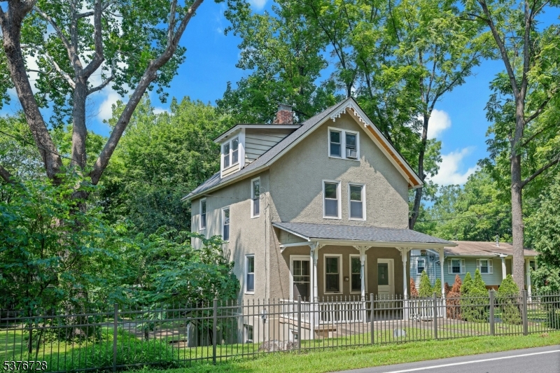 59 Main Street Peapack-Gladstone, NJ 07977 - Photo 2 of 30 a front view of a house with a garden