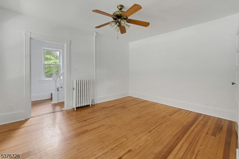 59 Main Street Peapack-Gladstone, NJ 07977 - Photo 6 of 30 a view of a room with wooden floor and a ceiling fan