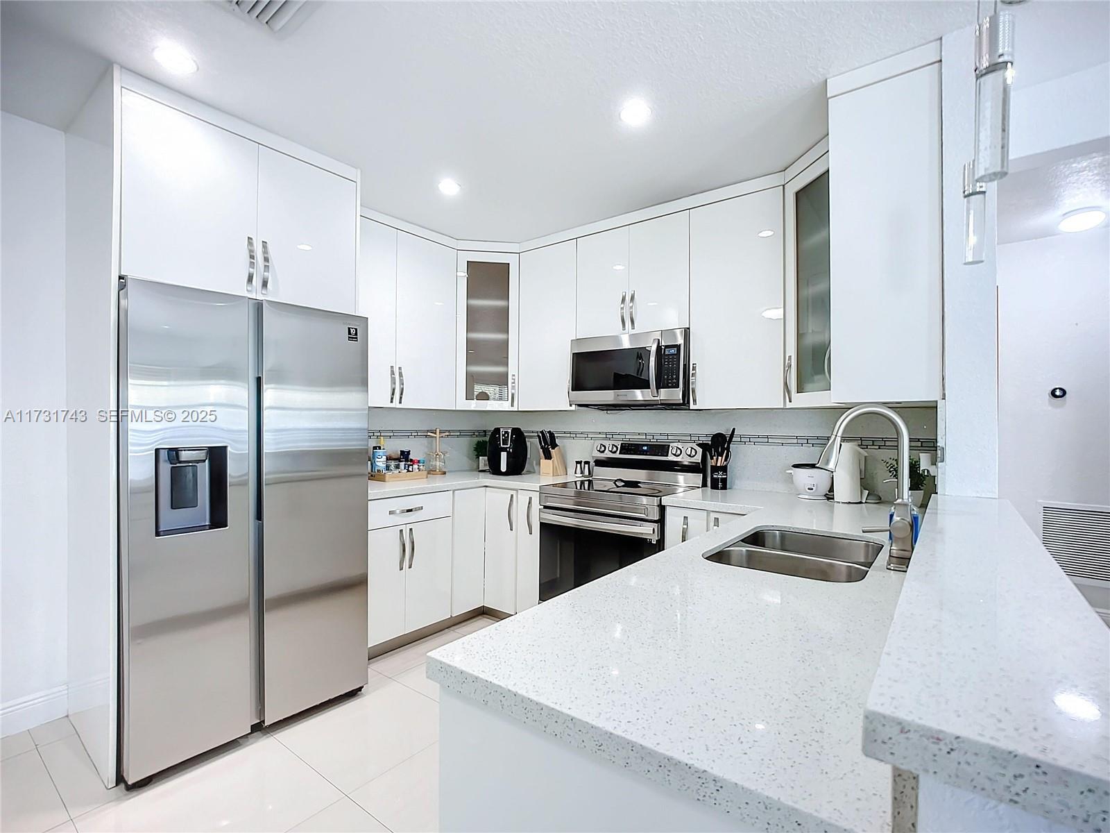35 Southwest 63rd Court Miami, FL 33144 - Photo 12 of 42 a kitchen with stainless steel appliances a refrigerator sink and microwave