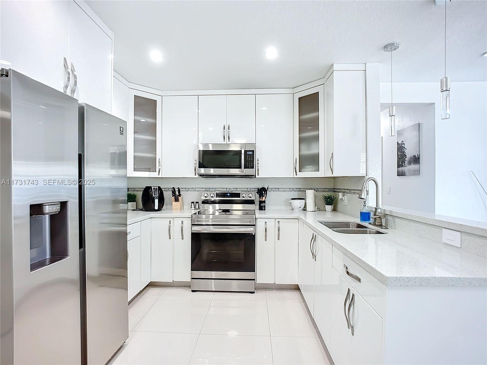 35 Southwest 63rd Court Miami, FL 33144 - Photo 13 of 42 a kitchen with cabinets stainless steel appliances a sink and a counter top space