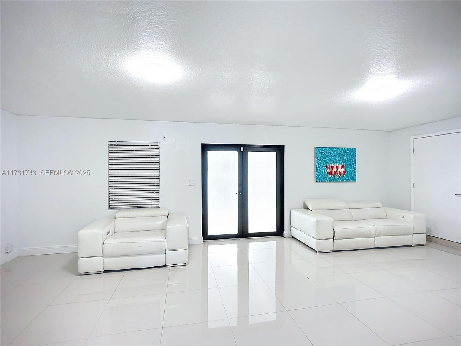 35 Southwest 63rd Court Miami, FL 33144 - Photo 14 of 42 a living room with furniture and a large window