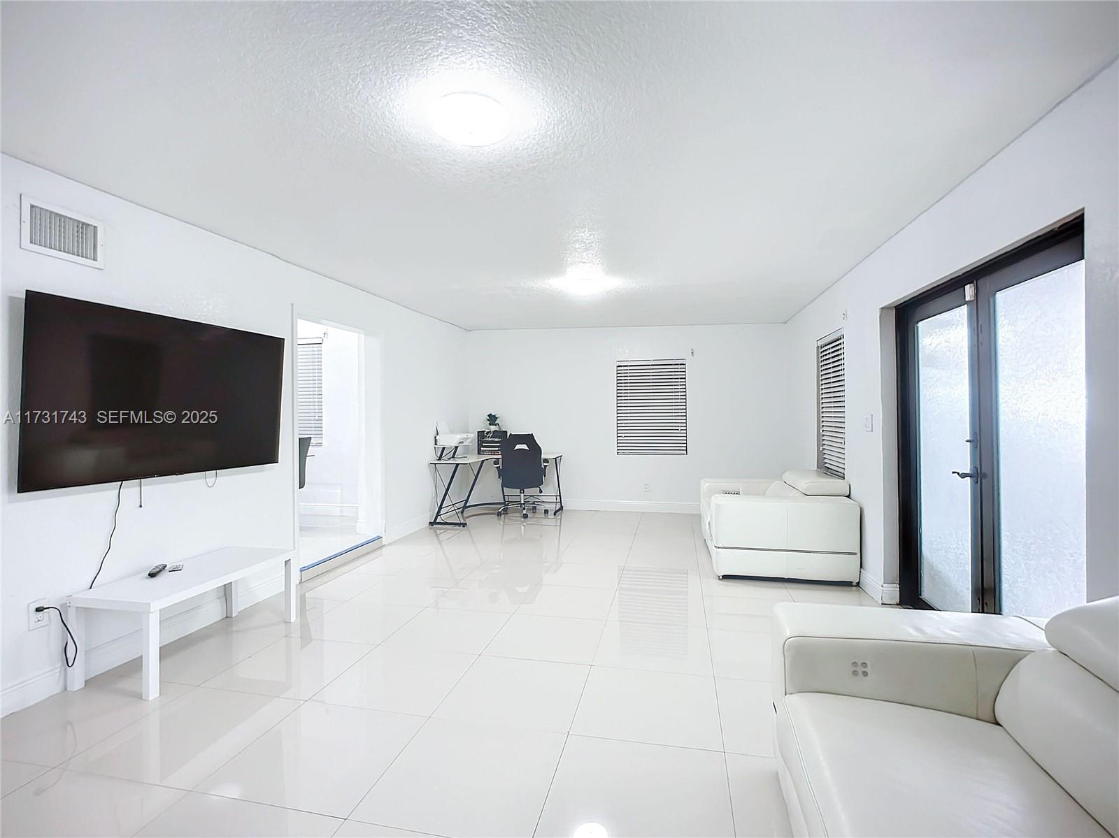 35 Southwest 63rd Court Miami, FL 33144 - Photo 16 of 42 a living room with furniture and a flat screen tv