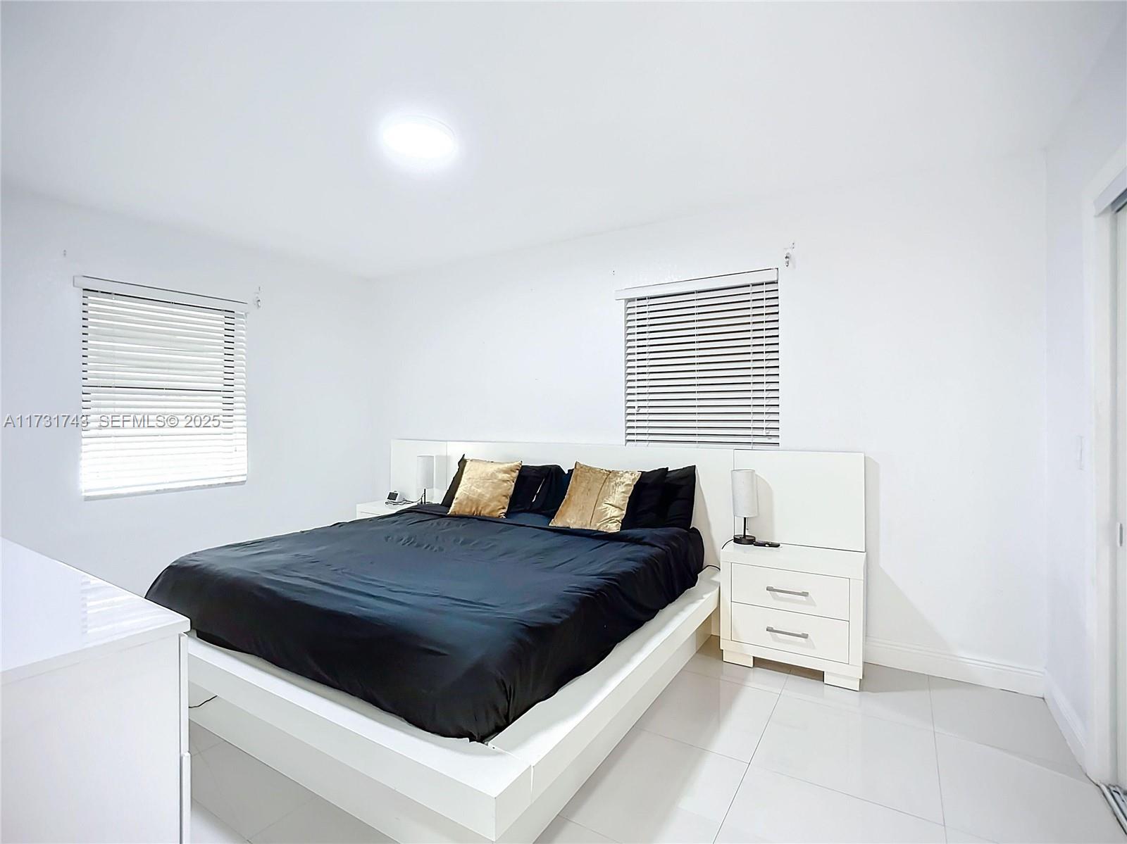 35 Southwest 63rd Court Miami, FL 33144 - Photo 17 of 42 a bed sitting in a bedroom next to a window