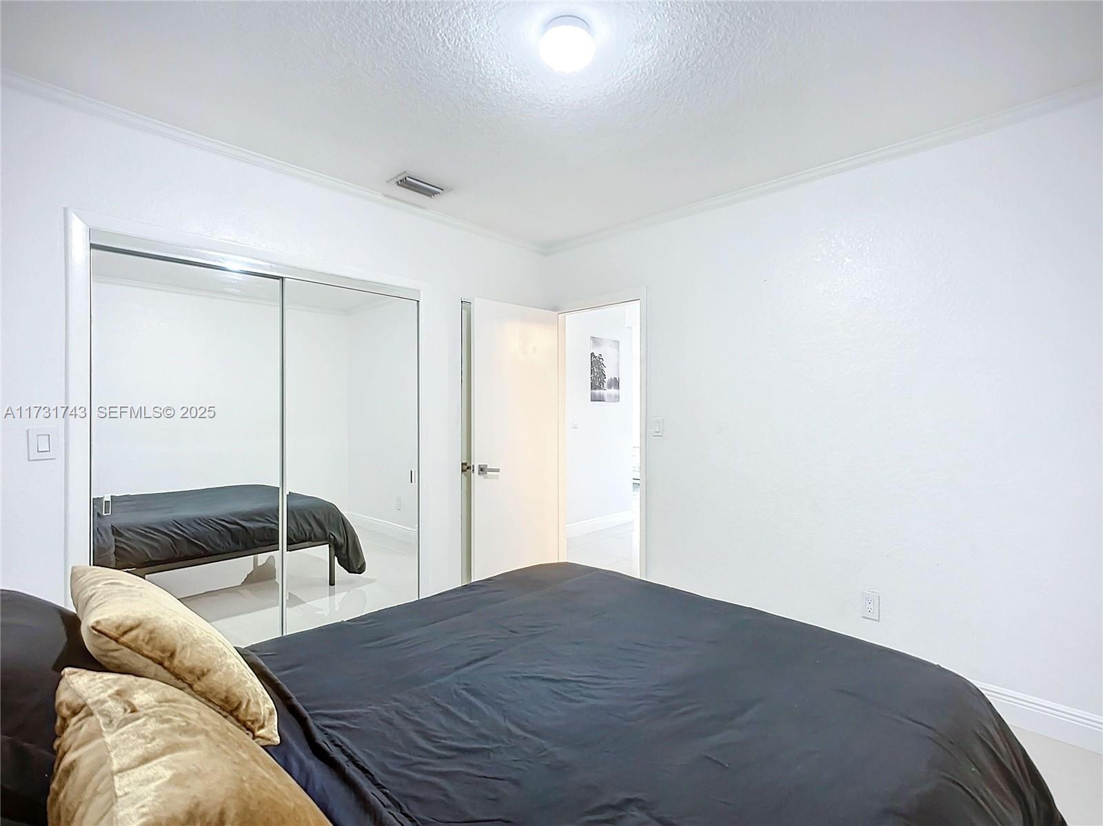 35 Southwest 63rd Court Miami, FL 33144 - Photo 21 of 42 a bedroom with a bed and a window