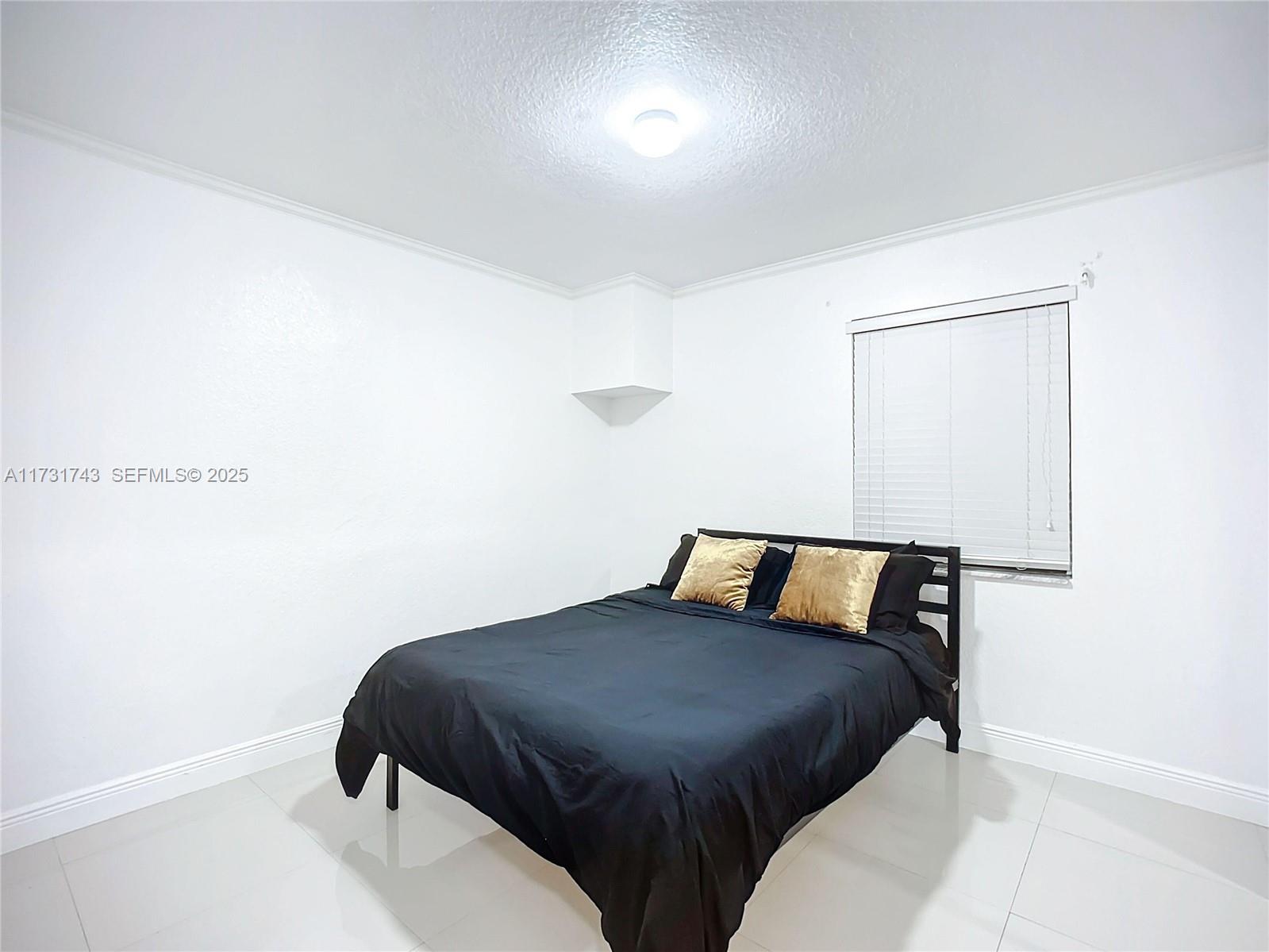 35 Southwest 63rd Court Miami, FL 33144 - Photo 23 of 42 a bedroom with a bed and mirror