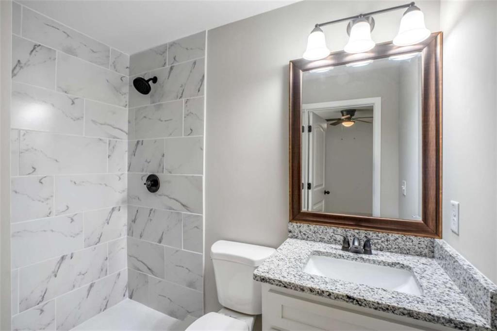 2159 Shiloh Road Greensboro, GA 30642 - Photo 20 of 43 a bathroom with a granite countertop sink toilet and shower