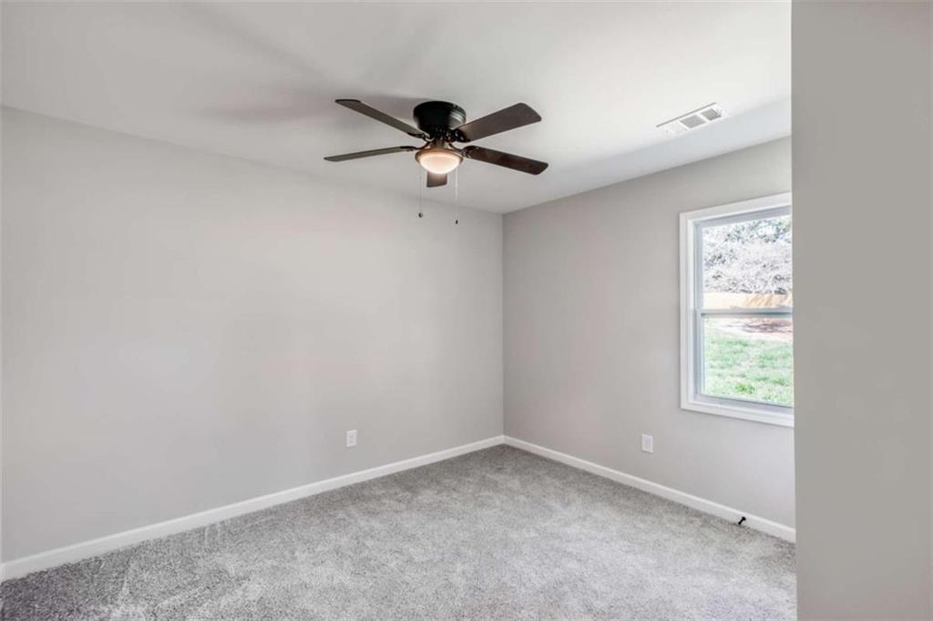 2159 Shiloh Road Greensboro, GA 30642 - Photo 21 of 43 an empty room with a window and a fan