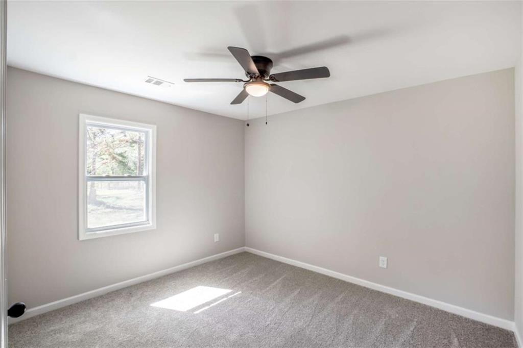 2159 Shiloh Road Greensboro, GA 30642 - Photo 23 of 43 an empty room with a window and a fan
