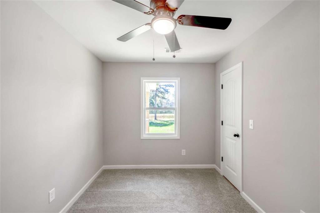 2159 Shiloh Road Greensboro, GA 30642 - Photo 25 of 43 an empty room with a window and a fan