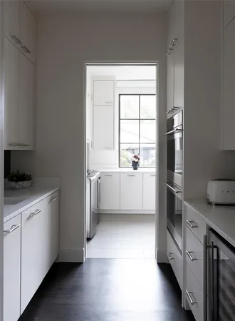 a kitchen with a cabinets a sink and a stove