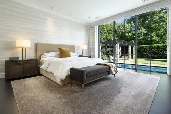 a bedroom with a bed and large window