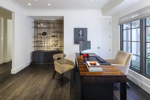 a view of a workspace with furniture and wooden floor