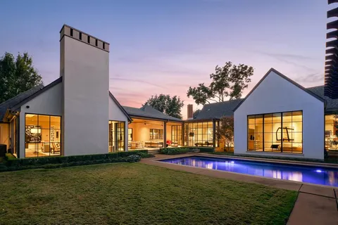 a view of swimming pool in front of house