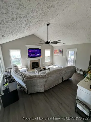 a kitchen with a refrigerator a stove a sink dishwasher and wooden cabinets with wooden floor