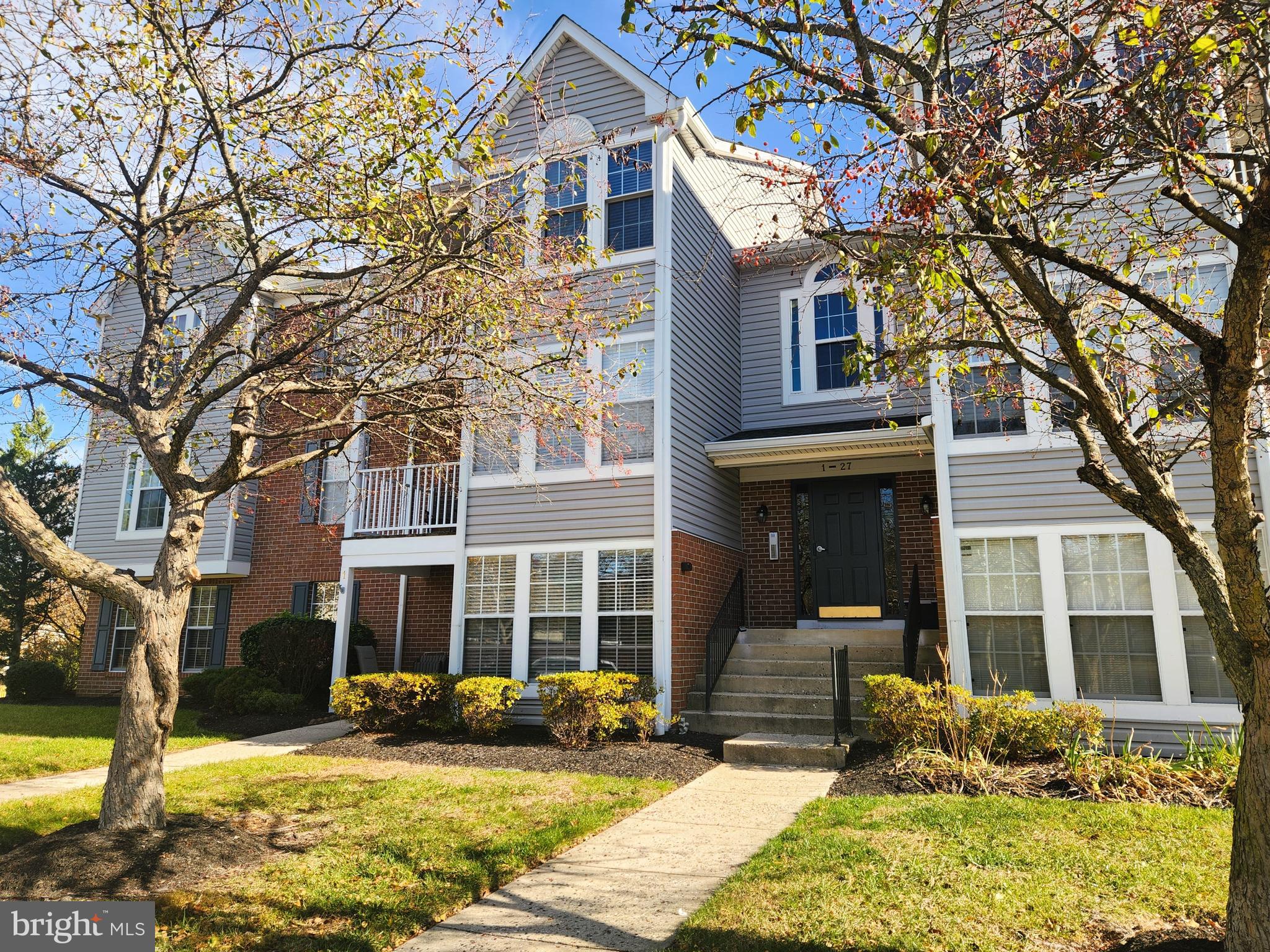 13 Locust Path Court, Unit 813 Nottingham, MD 21236 - Photo 1 of 23 a view of a brick house with plants and large tree