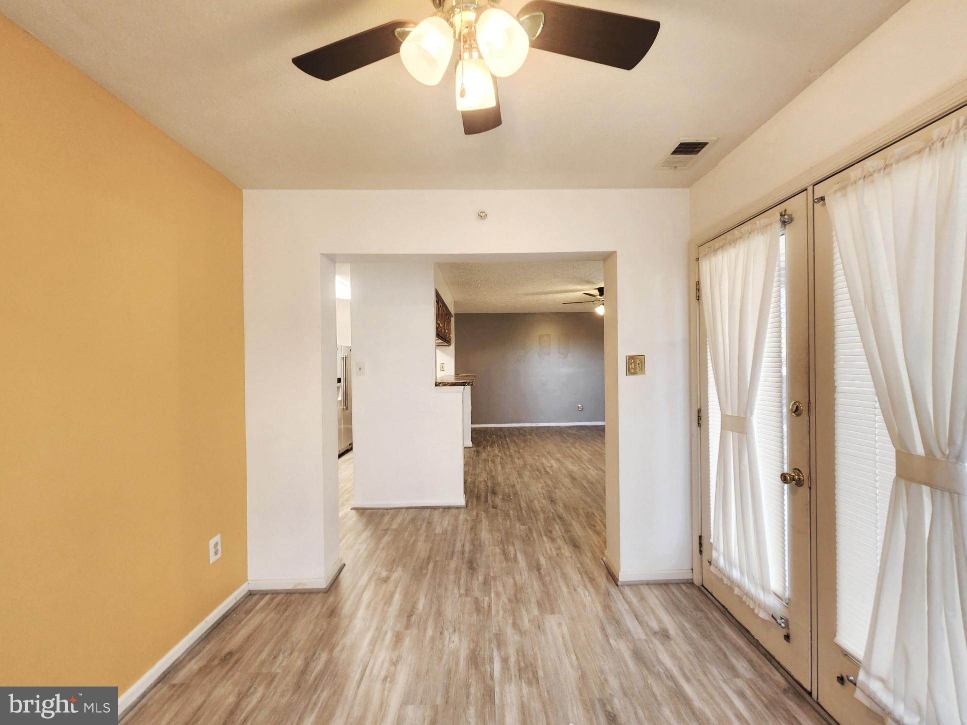13 Locust Path Court, Unit 813 Nottingham, MD 21236 - Photo 12 of 23 wooden floor in an empty room with a window