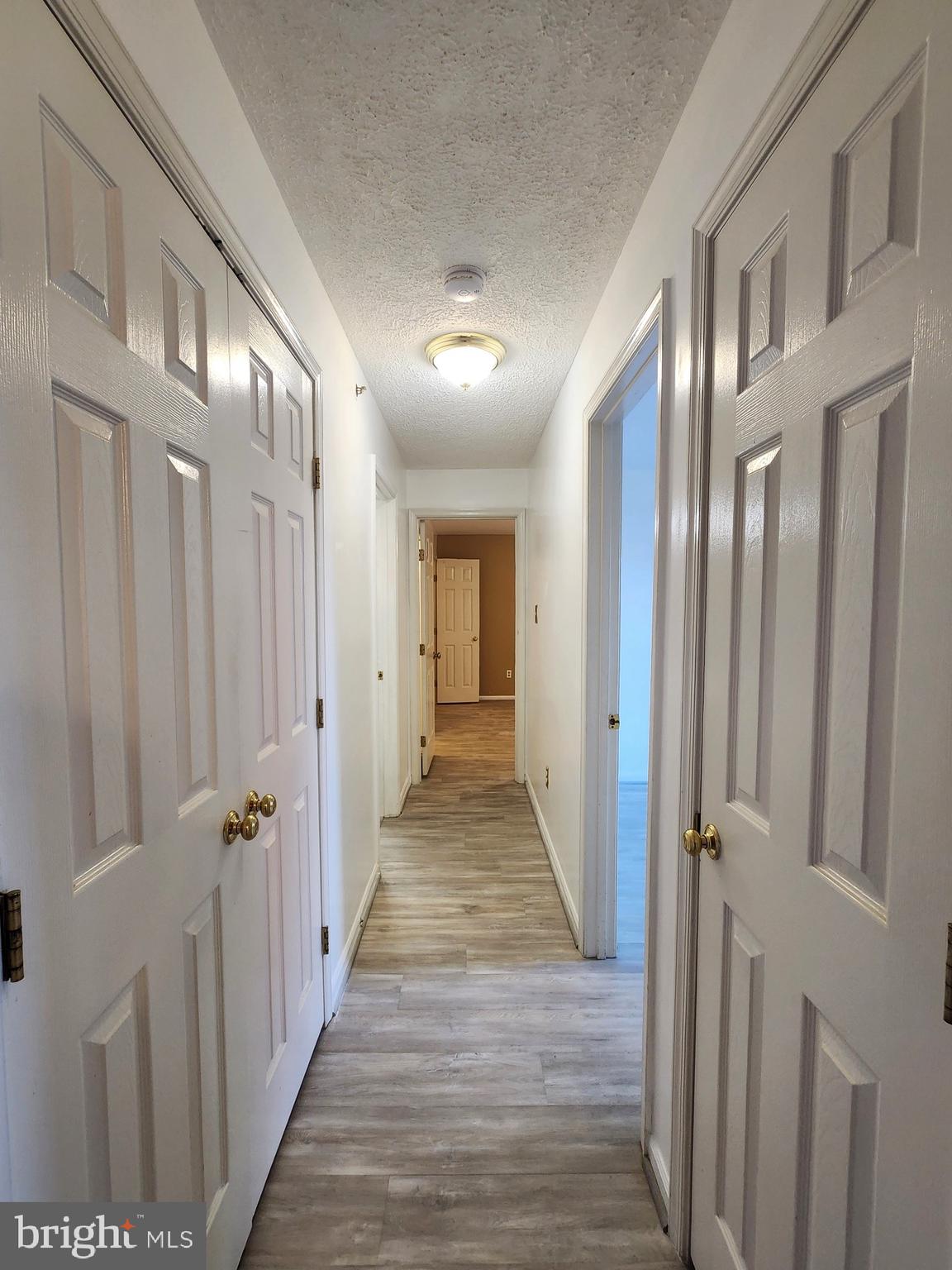 13 Locust Path Court, Unit 813 Nottingham, MD 21236 - Photo 14 of 23 a view of a hallway with wooden floor