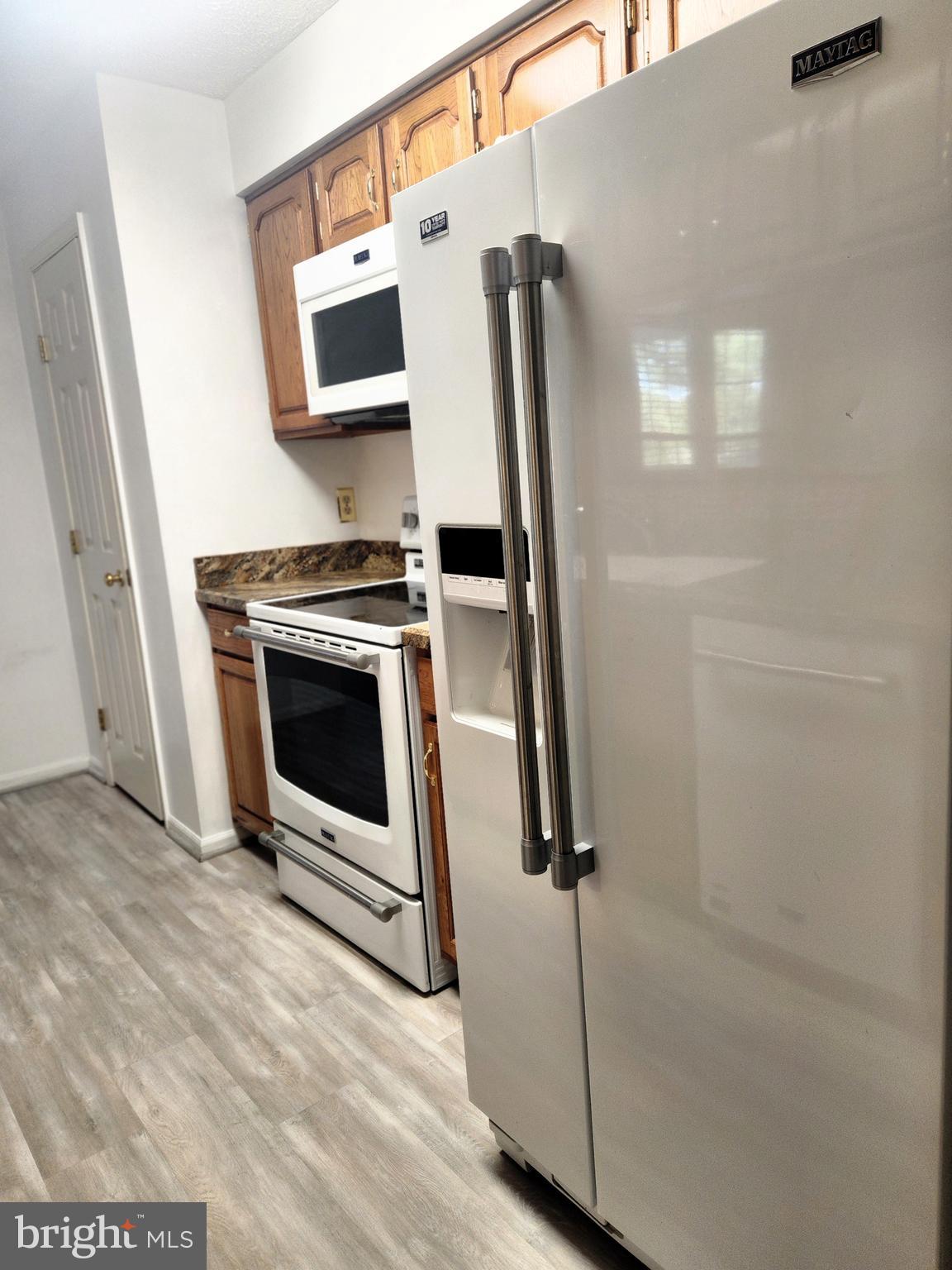 13 Locust Path Court, Unit 813 Nottingham, MD 21236 - Photo 8 of 23 a kitchen with a stove and a refrigerator