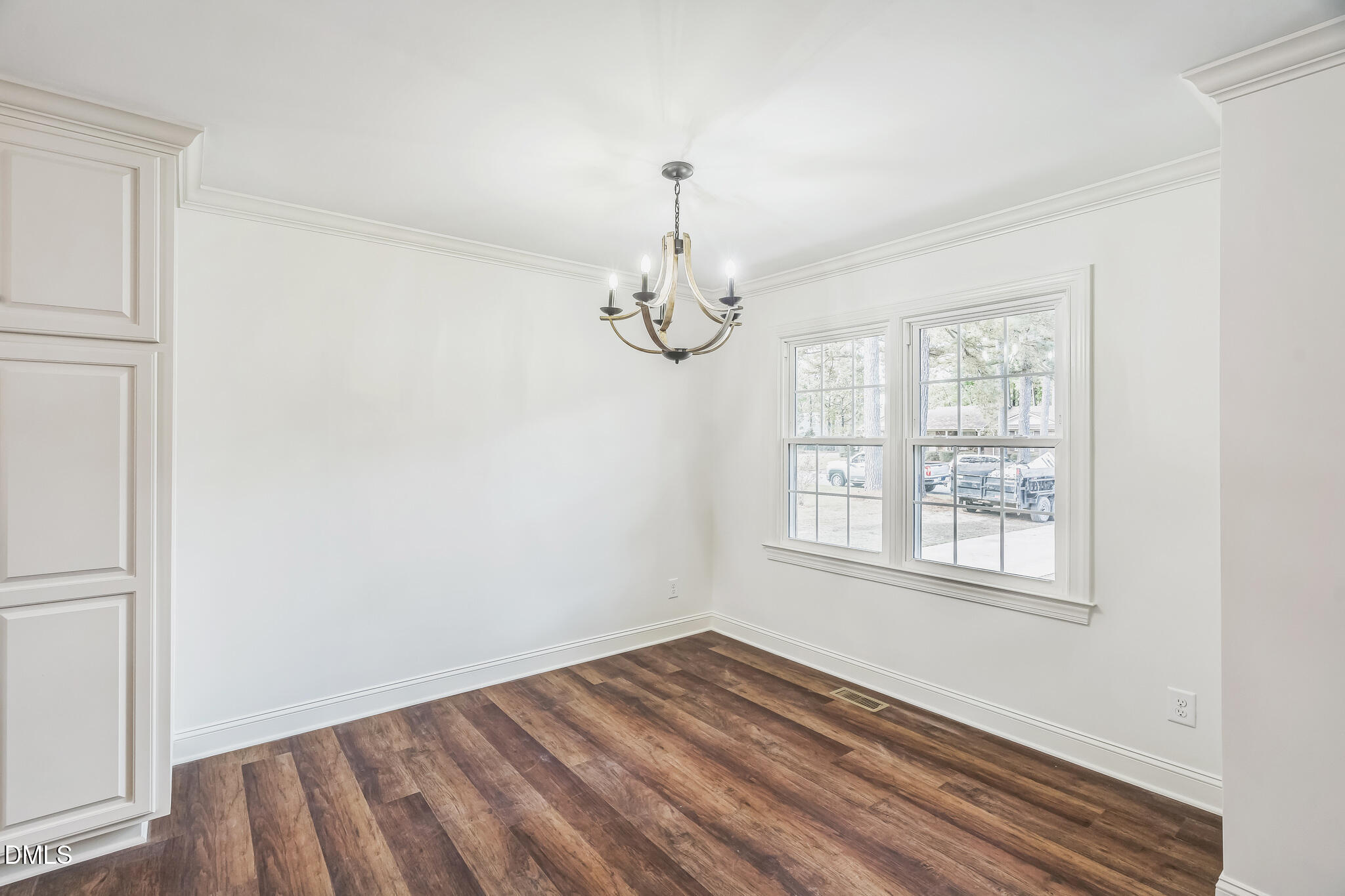1219 Queen Anne Road Northwest Wilson, NC 27896 - Photo 16 of 26 an empty room with wooden floor fan and windows