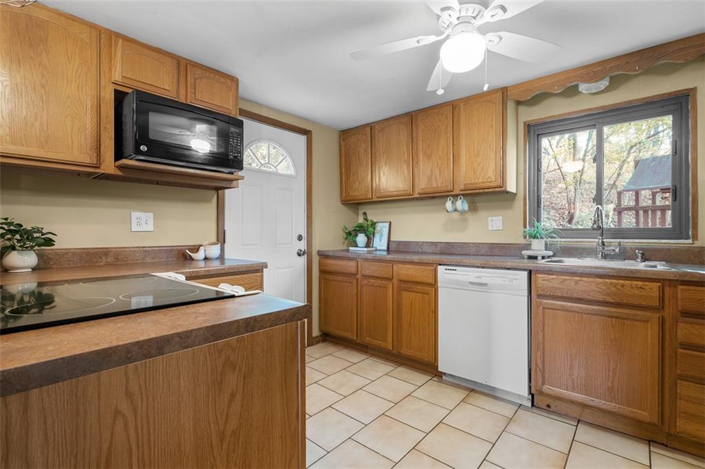 1670 Breining Street Pittsburgh, PA 15234 - Photo 14 of 39 a kitchen with a sink stove and microwave