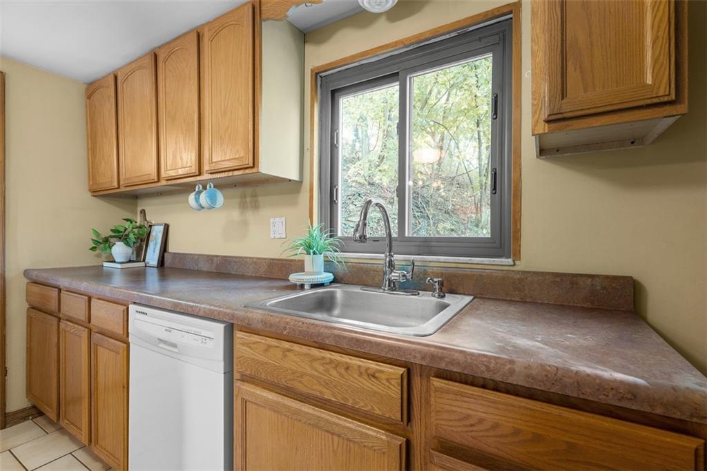 1670 Breining Street Pittsburgh, PA 15234 - Photo 15 of 39 a kitchen with granite countertop stainless steel appliances a sink window and cabinets